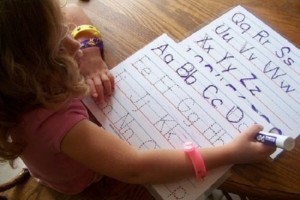 child tracing letters