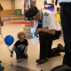 Pilot talking with a little boy in the airport