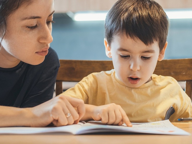 Teacher teaching student to read